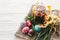 happy Easter concept. stylish painted eggs and easter cake on white rustic wooden background with spring flowers and candle. seas