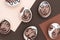 Happy Easter concept. Surreal faces on eggs on brown background. Art und Online style. Top view Flat lay
