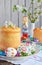 Happy Easter concept. Sweet bread with dried fruits and colored eggs. Holidays breakfast. Orthodox kulich. Festive table place