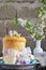 Happy Easter concept. Sweet bread with dried fruits and colored eggs. Holidays breakfast. Orthodox kulich. Festive table place