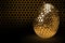 Happy Easter egg hive with bee on honey comb  Shiny hexagonal gold big eggs on a black background with bee