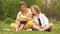 Happy Easter family with Easter basket on a spring picnic. One year old baby, his mom and elder brother