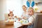 Happy easter! family mother and children paint eggs for holida