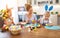 Happy easter! family mother and children paint eggs for holida