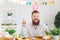 Happy easter. Funny male bearded man smiling gets out pointing his finger at Easter background