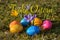 Happy Easter in German with several colorful Easter eggs lying o