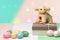 Happy Easter greeting card. Decorative composition of colorful eggs, a gift box with a easter lamb on it on a multicolour table in