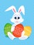 Happy Easter greeting card with eggs and rabbit. White cute Easter Bunny with colorful eggs.