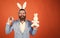 happy easter handsome caucasian businessman with trendy hairstyle in jacket, bunny ears