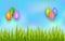 Happy Easter hanging painted eggs on sky background with green grass. Poster template with copy space.