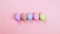 Happy Easter holiday concept stop motion animation. Colorful egg appear in row on pink background, top view