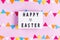Happy easter lettering on white board with felt garland on pink background