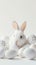 Happy Easter! Monochromatic white banner with easter bunny rabbit on white background, surrounded by white eggs