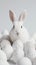 Happy Easter! Monochromatic white banner with easter bunny rabbit on white background, surrounded by white eggs