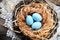 Happy Easter postcard with pretty blue eggs in the nest with lace and burlap