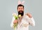 Happy Easter. Rabbit man in bunny ears with flower and basket eggs. Happy guy in suit with tulips.