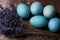 Happy Easter rustic concept with copy space. DIY dyed various shades of blue Easter eggs with lavender.