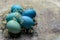 Happy Easter rustic concept. DIY dyed various shades of blue Easter eggs on retro rusty metal background.
