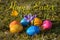 Happy Easter with several colorful Easter eggs lying on grass wi