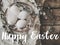 Happy Easter text on easter eggs on vintage plate, feathers, pussy willow branches on aged wood, handwritten sign. Beautiful