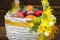 Happy Easter. Traditionally, colorfully painted eggs in a basket. Background of old boards, festive decor.