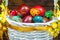 Happy Easter. Traditionally, colorfully painted eggs in a basket. Background of old boards, festive decor.