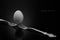 Happy Easter,white egg two forks ancient silver on a black