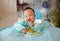 Happy eating Asian baby boy, 7 months old eating with Baby Led Weaning BLW method, Self-Feeding