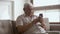 Happy elder senior man holding smartphone using mobile online apps