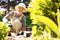 Happy elder woman working in her garden