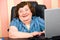 Happy elderly business woman using laptop