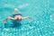 Happy elderly caucasian swimming in pool during retirement holiday with relaxation and smiling