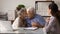 Happy elderly couple close deal with bank specialist