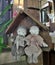 Happy elderly couple cloth dolls sitting in wooden cottage