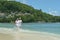 Happy elderly couple running on tropical beach