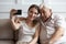 Happy elderly father and adult daughter make selfie together