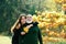 Happy elderly father and daughter enjoying autumn moment, smiling, hugging, cuddling. Grown up granddaughter with