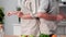 happy elderly husband and wife have fun dancing at table in the kitchen, close-up