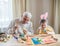 Happy elderly man granfather preparing for Easter with grandson. Portrait of smiling boy with bunny ears painted  colored eggs for