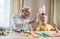 Happy elderly man granfather preparing for Easter with grandson. Portrait of smiling boy with bunny ears painted  colored eggs for