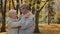 Happy elderly married couple dancing in autumn park enjoy romantic dance together loving old middle aged grandparents