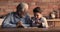 Happy elderly mature man playing checkers with little grandson.