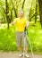 Happy elderly people engaged in Nordic walking and showing thumbs up