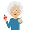 Happy elderly woman holding a red apple giving thumbs up