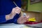 Happy elderly woman painting for fun at home. Senior Caucasian senior woman painting. Retirement hobby. Elderly woman painting on