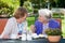 Happy Elderly Women Chatting at the Garden Table