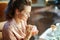 Happy elegant housewife with cosmetic jar applying eye cream