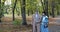 Happy, elegant, retired family couple walking and having pleasant talk in autumn