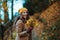 Happy elegant woman in brown coat and hat walking