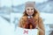 happy elegant woman in brown hat and scarf in camel coat